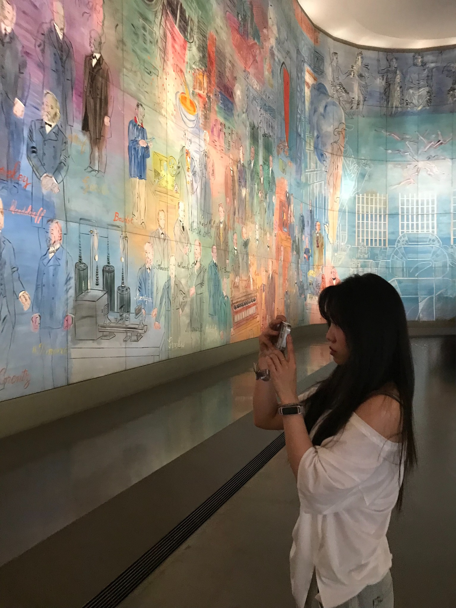 Weiwei photographing a colourful exhibition for her social media content.