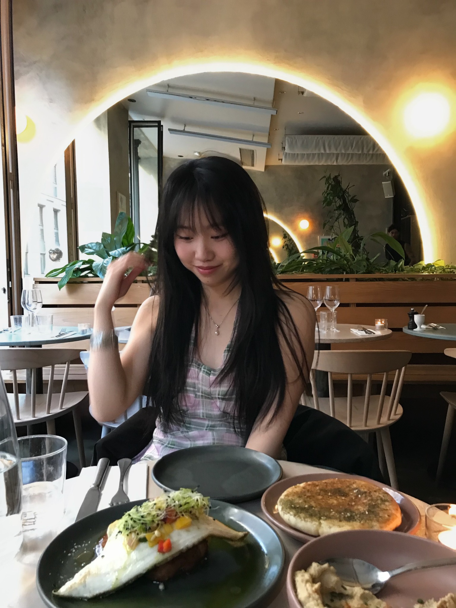 Weiwei experiencing a restaurant partnership with the venue and dishes visible.