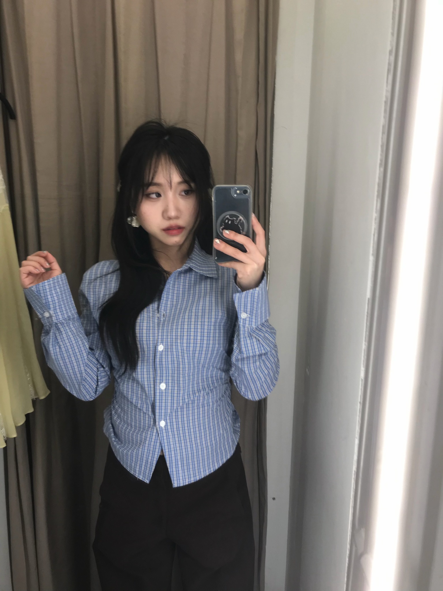 Weiwei creating mobile-first fashion and lifestyle content in front of a mirror.